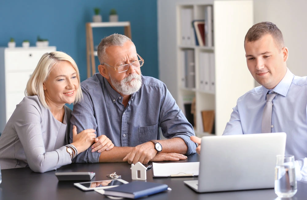 A couple having a meeting with kitchen designer for kitchen remodeling plan