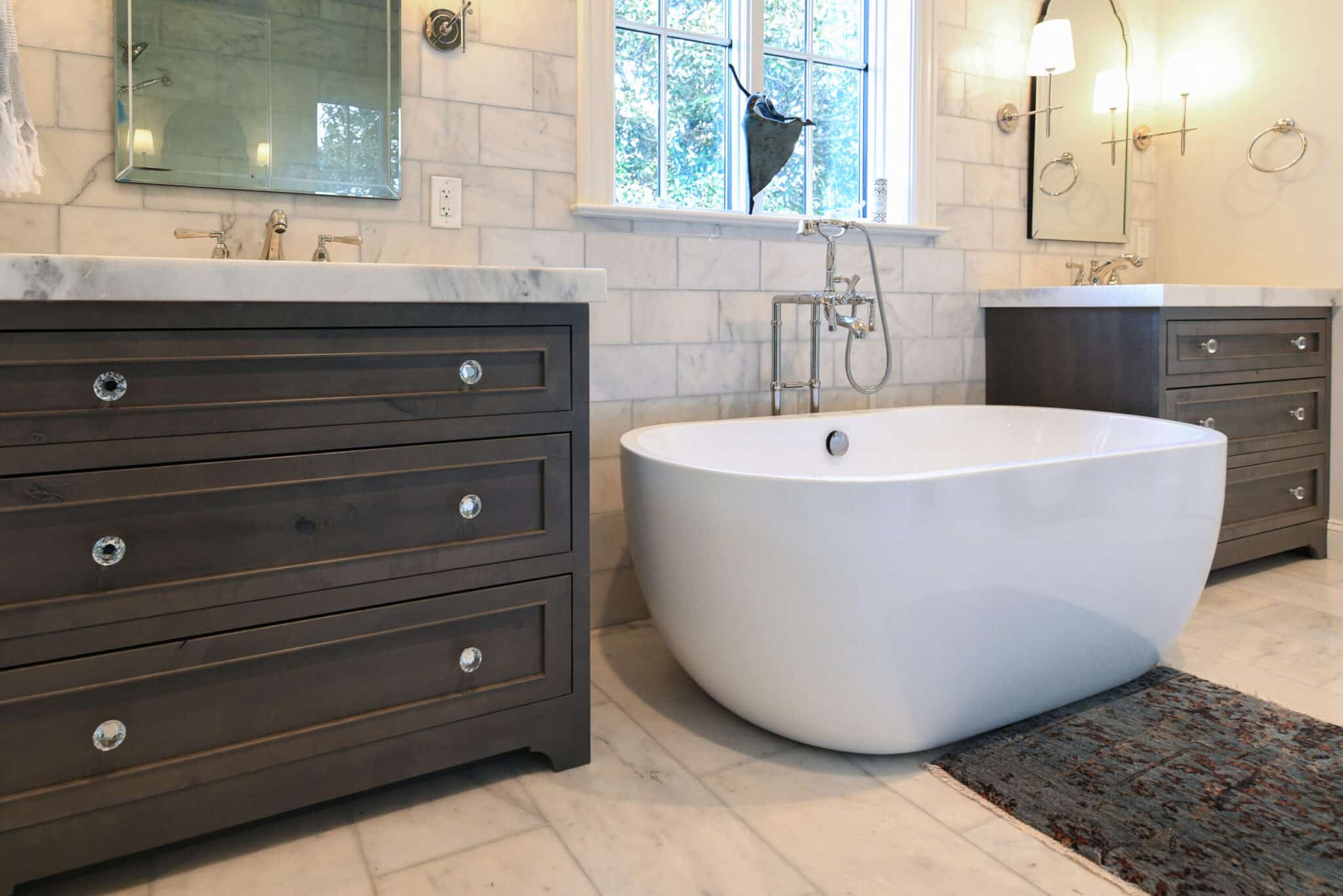 Modern bathroom style with two dark brown cabinets and bath tub in between