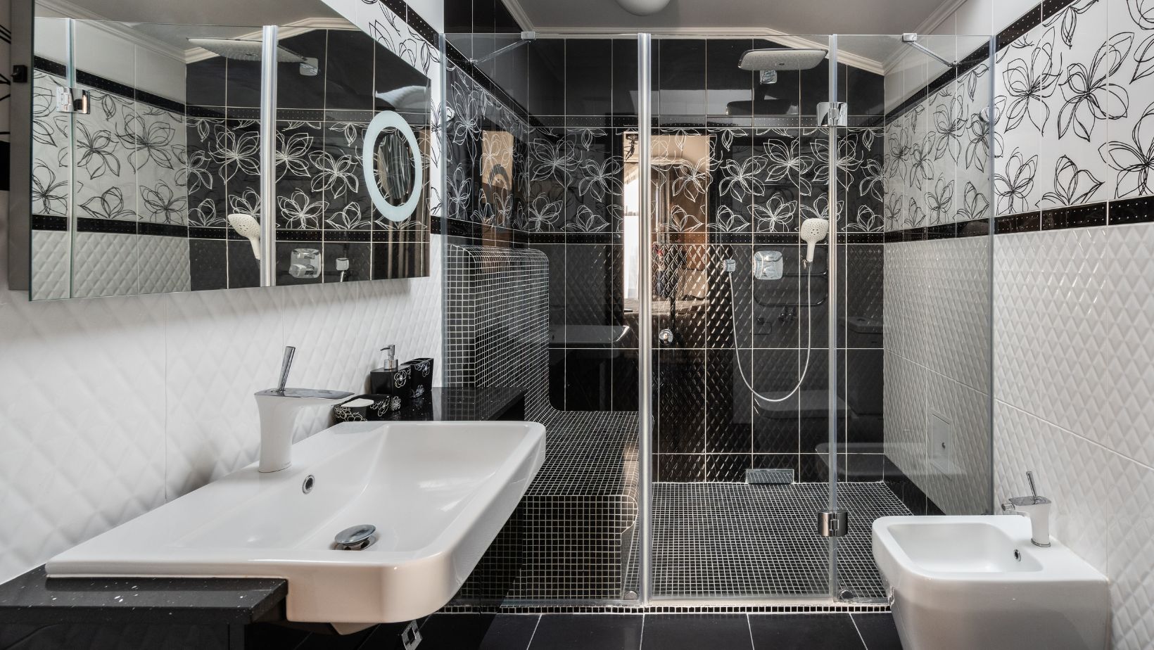 Luxury black bathroom with black cabinets, shower and a toilet