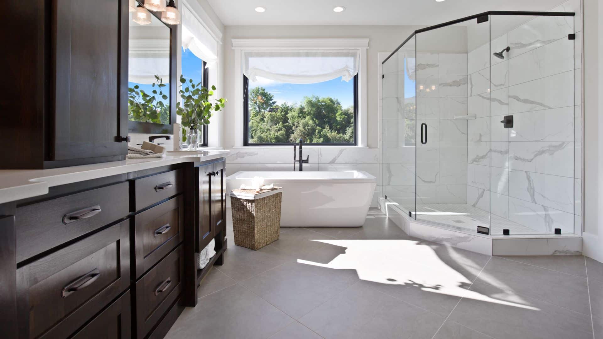Spacious luxury white bathroom with dark brown cabinet, bath tub, and a neo angle shower