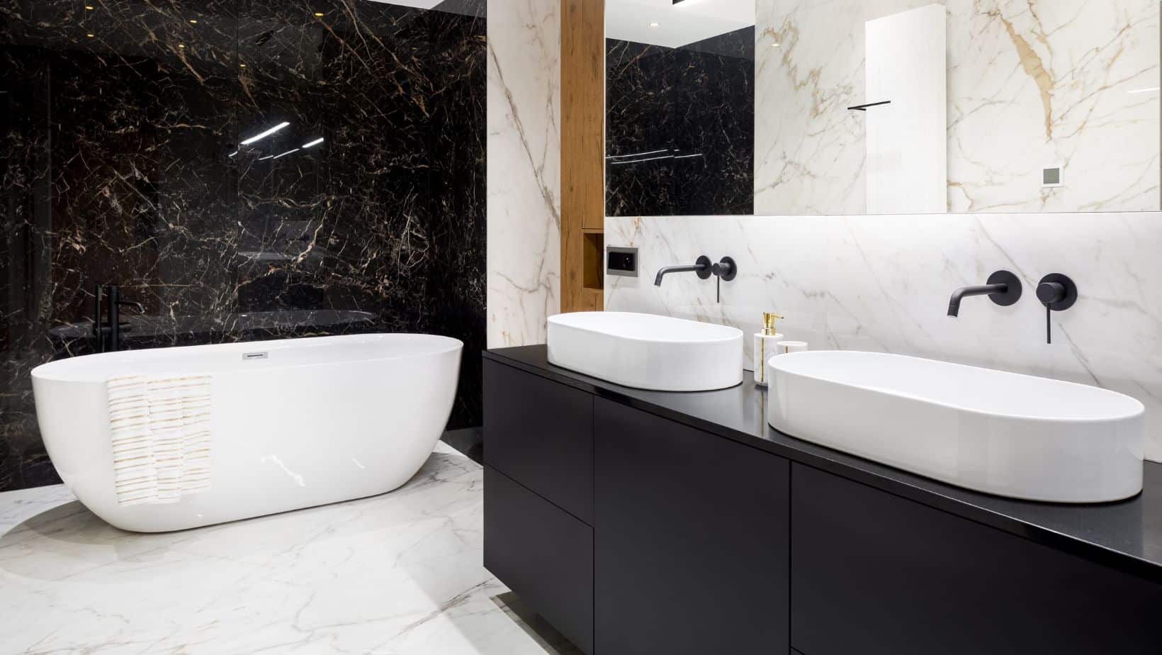 Modern bathroom with black vessel sink cabinets and bath tub