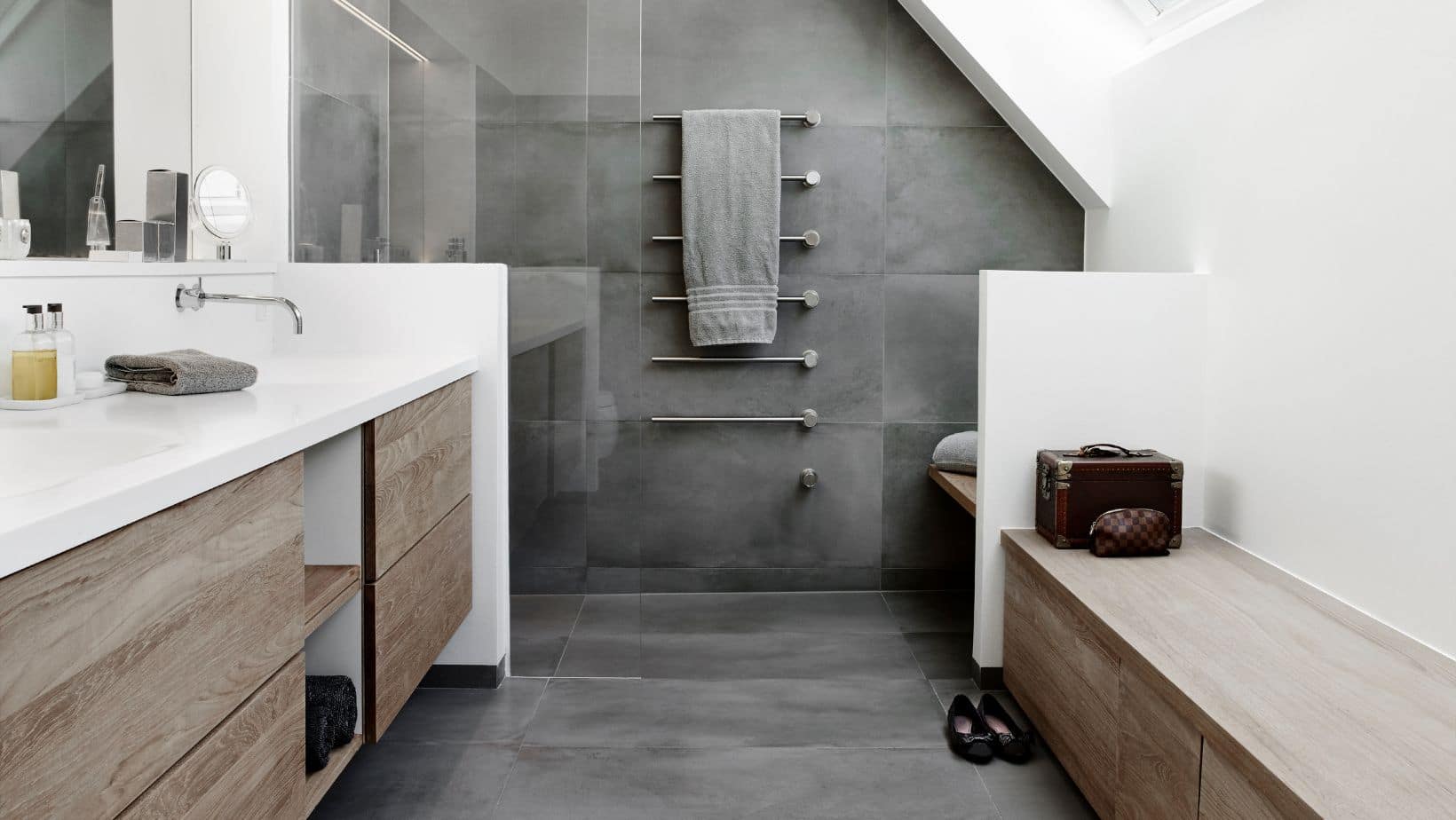 Grey modern style bathroom with wood cabinet, bench, and walk-in shower