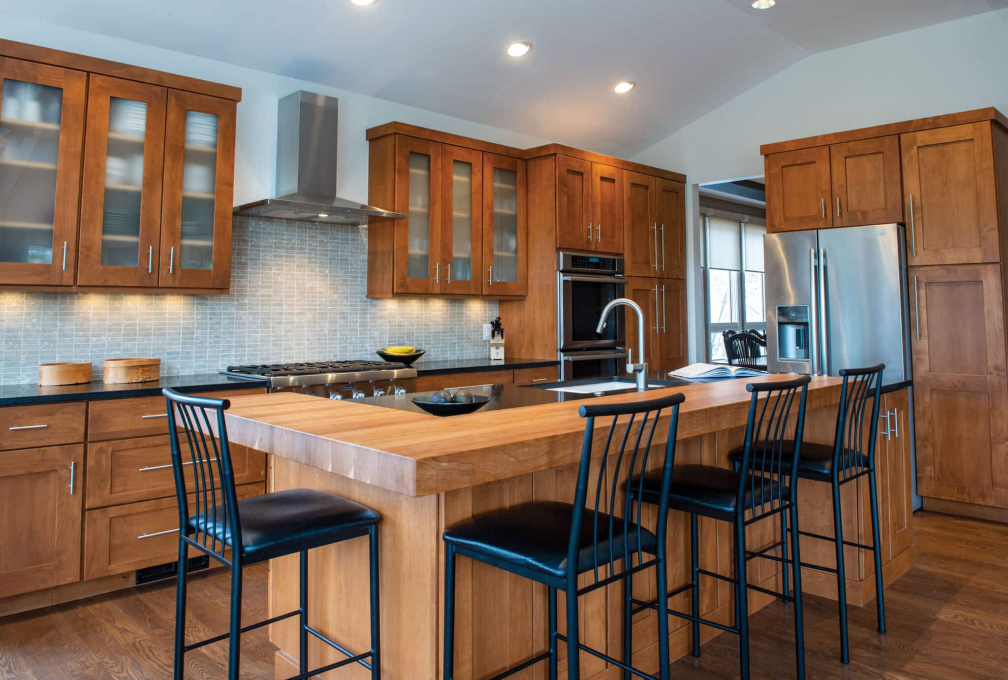 Woodharbor wood kitchen cabinets with black countertops and wood kitchen island top