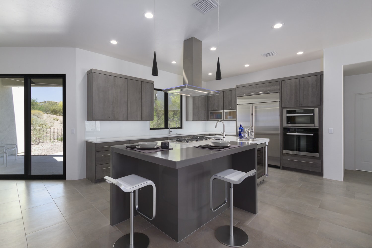 Woodharbor dark brown kitchen cabinets with white countertops and dark grey kitchen island top