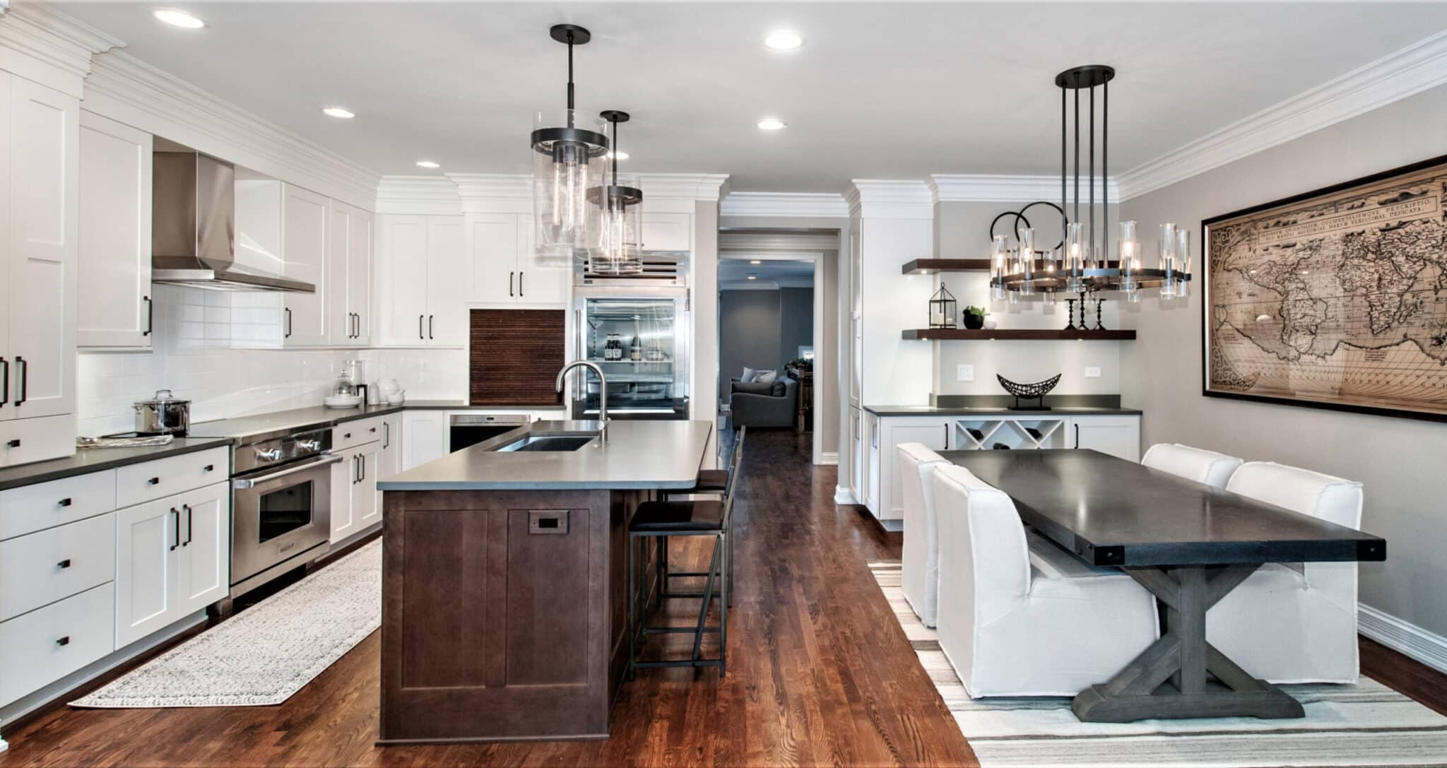 Woodharbor white kitchen cabinets with black countertops and dark brown kitchen island with grey countertop