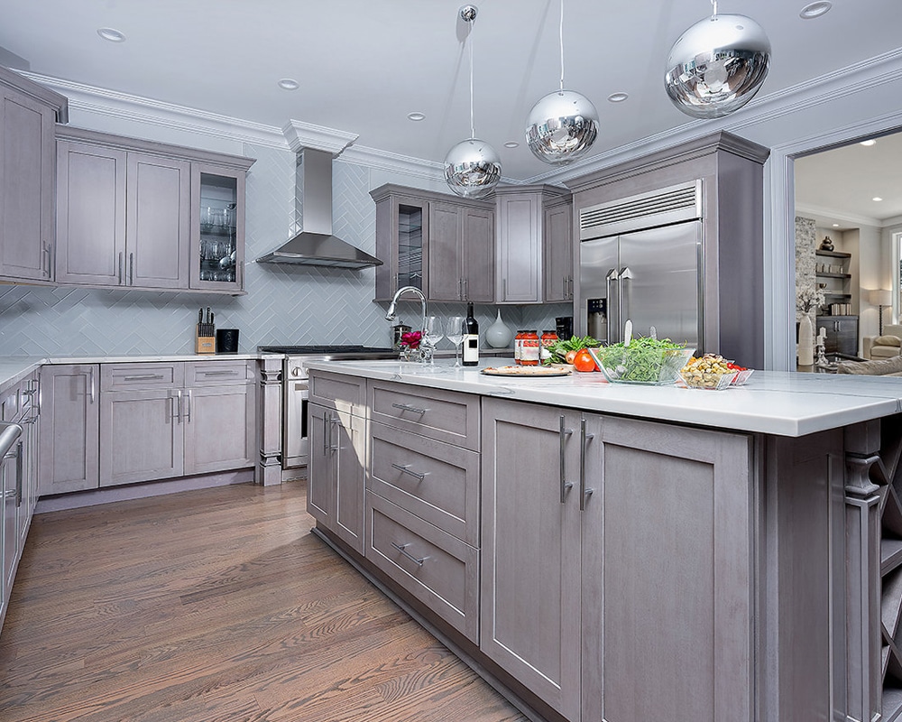 Gray shaker kitchen cabinet with white countertop