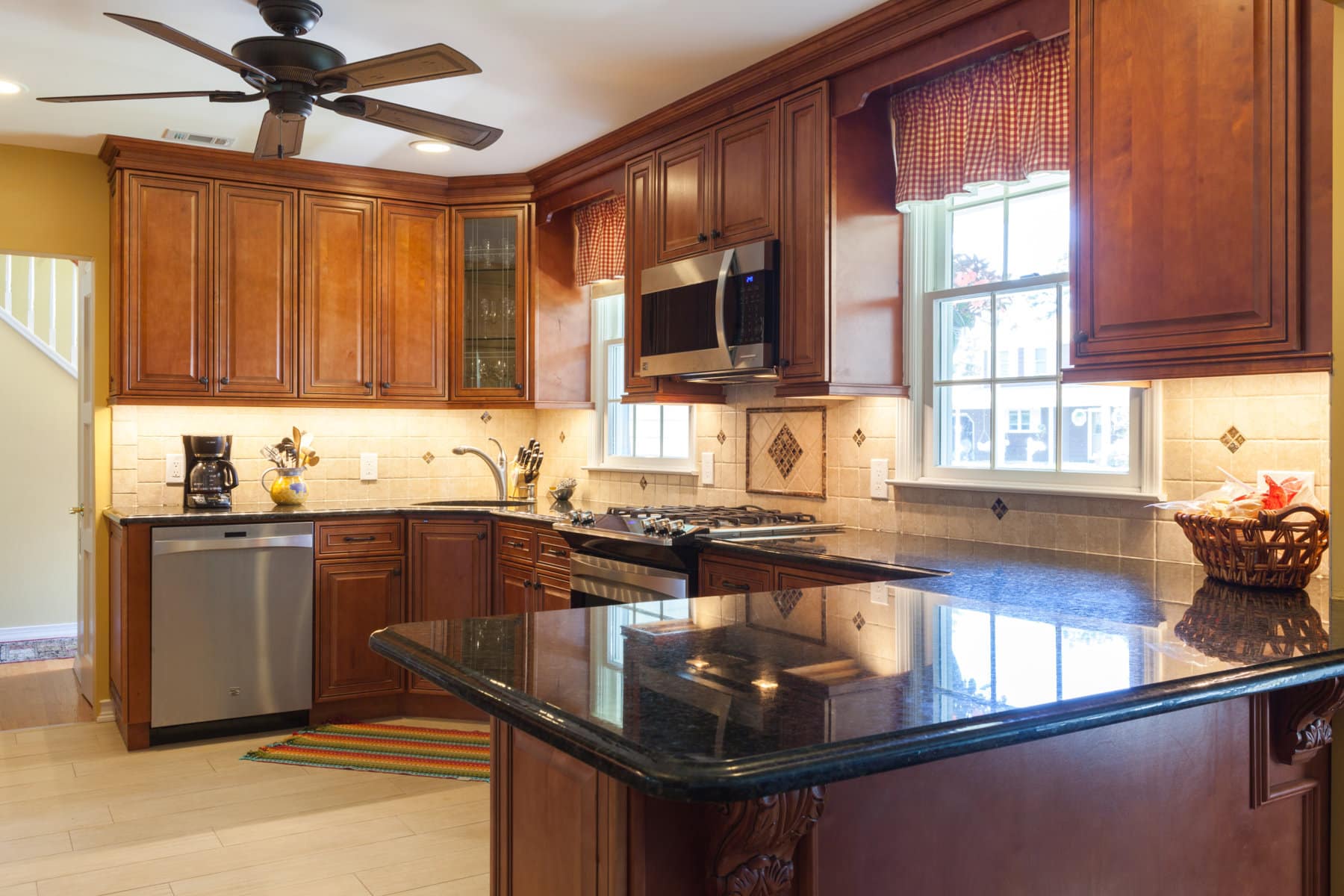 J&K brown kitchen cabinets with black countertops