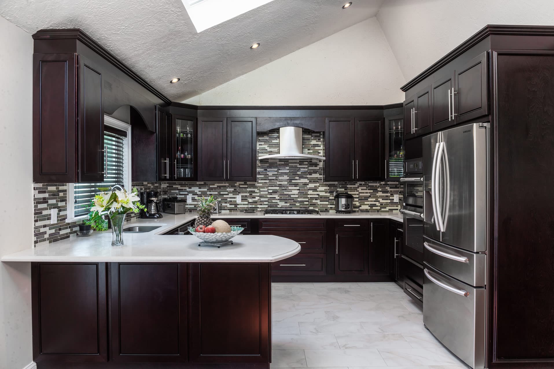J&K dark brown kitchen cabinets with white countertops