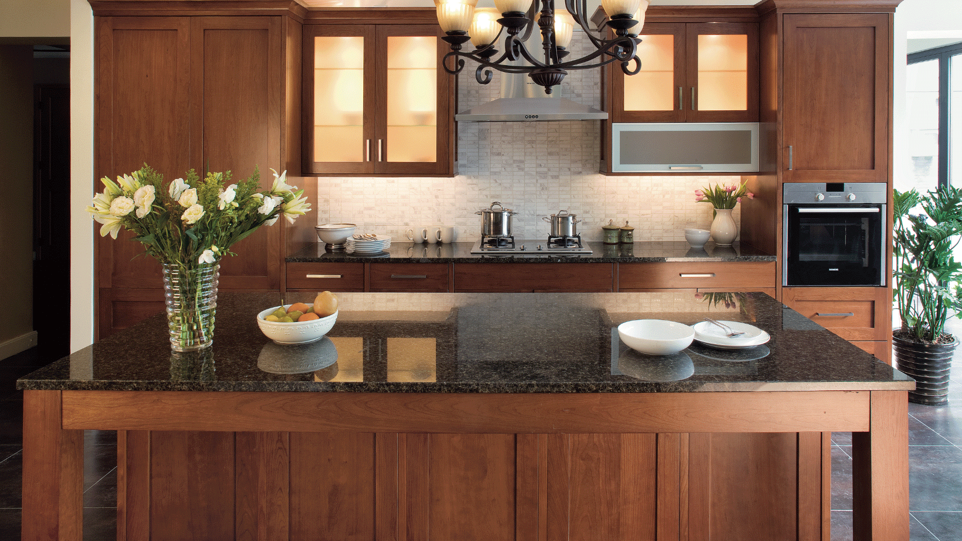 St. Martin wood kitchen cabinets with black countertops