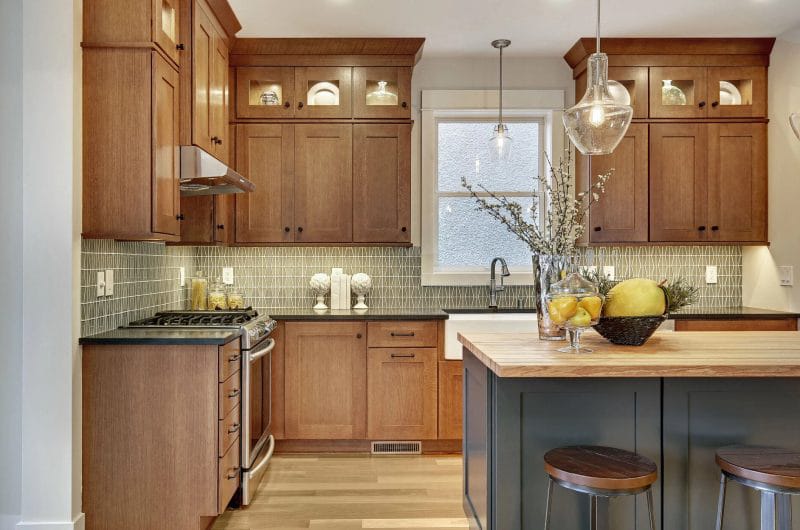 Traditional kitchen design with black countertops on wood cabinets