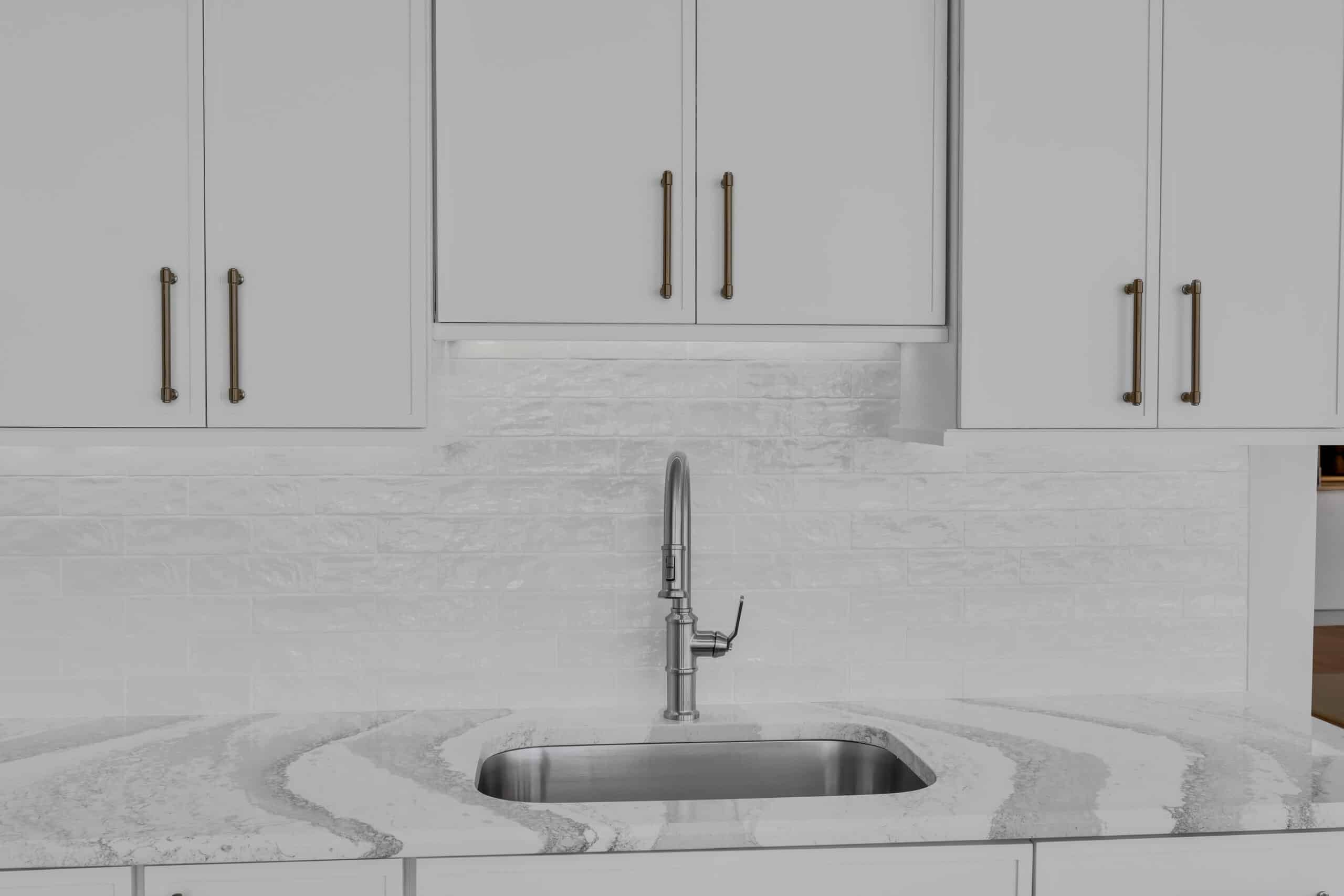 Minimalist sink and faucet on white quartz countertop
