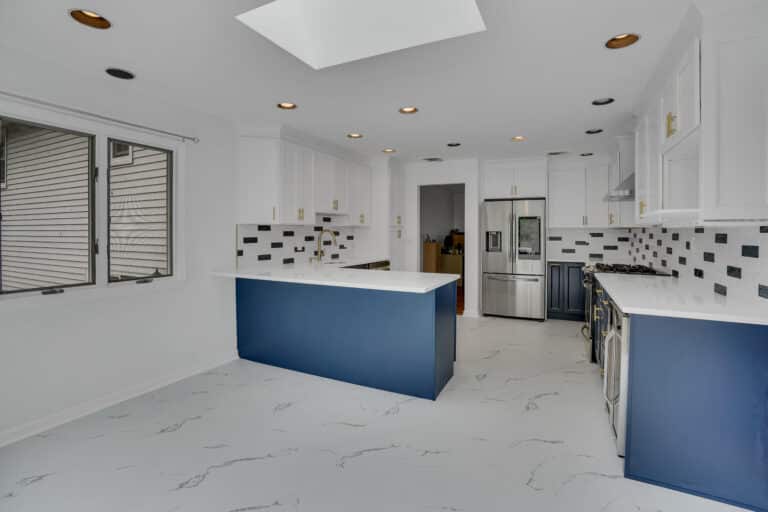 Elegant kitchen design with Blue and White shaker cabinets, and white countertops