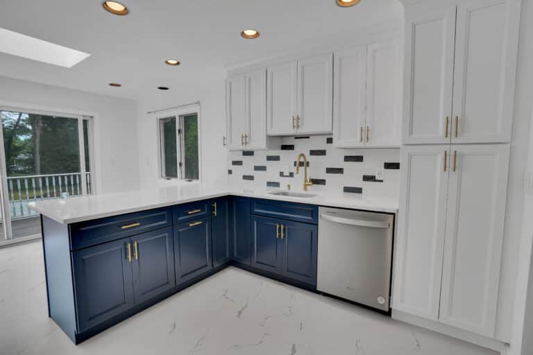 Elegant kitchen design with Blue and White shaker cabinets, and white countertops