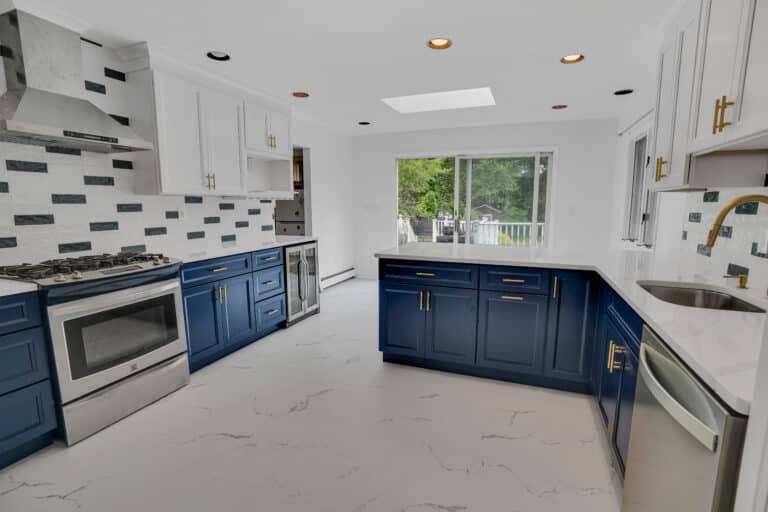 Elegant kitchen design with Blue and White shaker cabinets, and white countertops