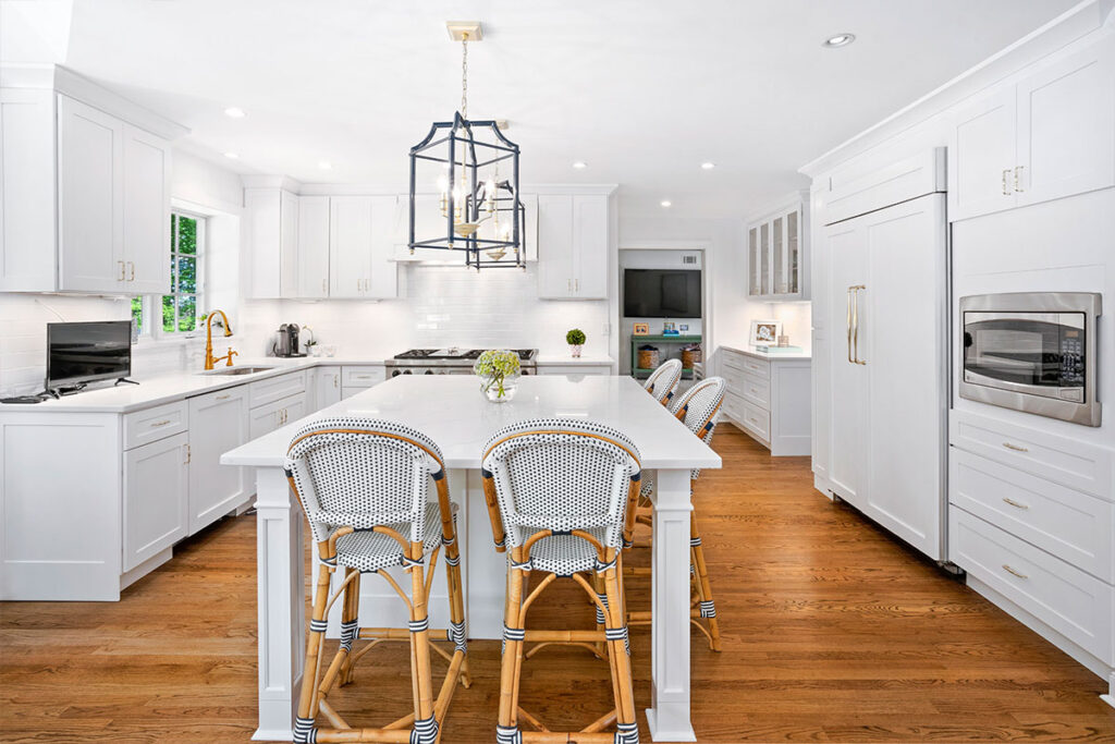 Bright white kitchen design with wood flooring and Tribeca Hudson Kitchen Cabinets