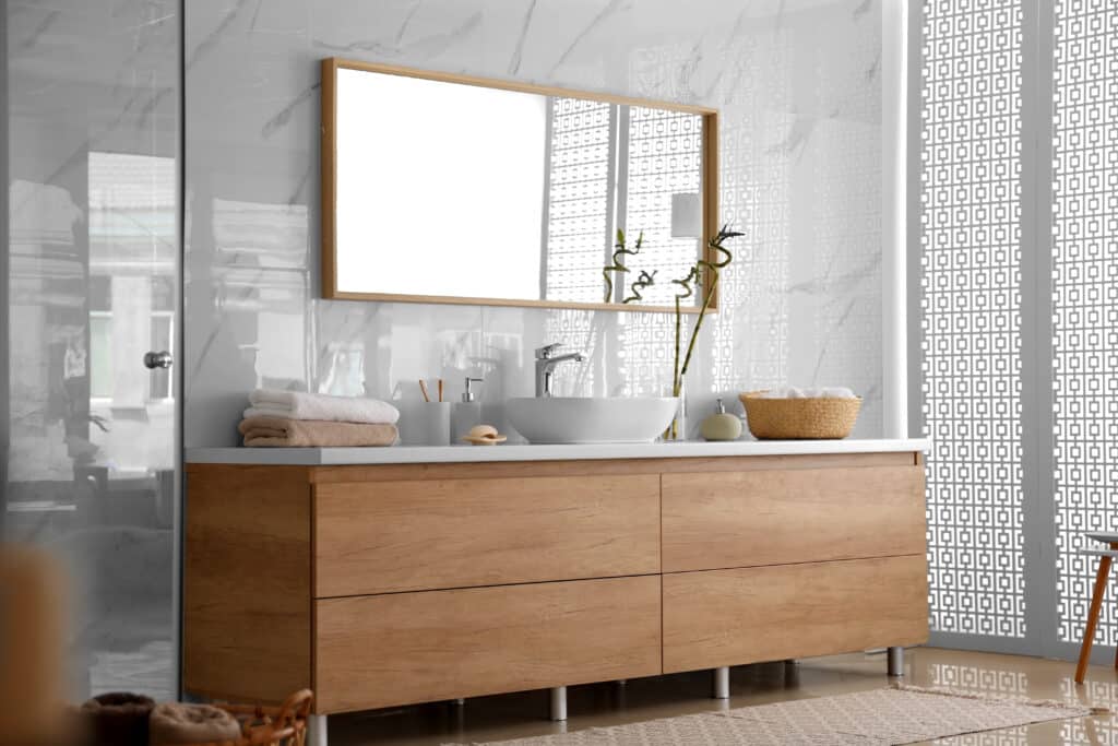 Brown bathroom vanity with white countertop and vessel sink
