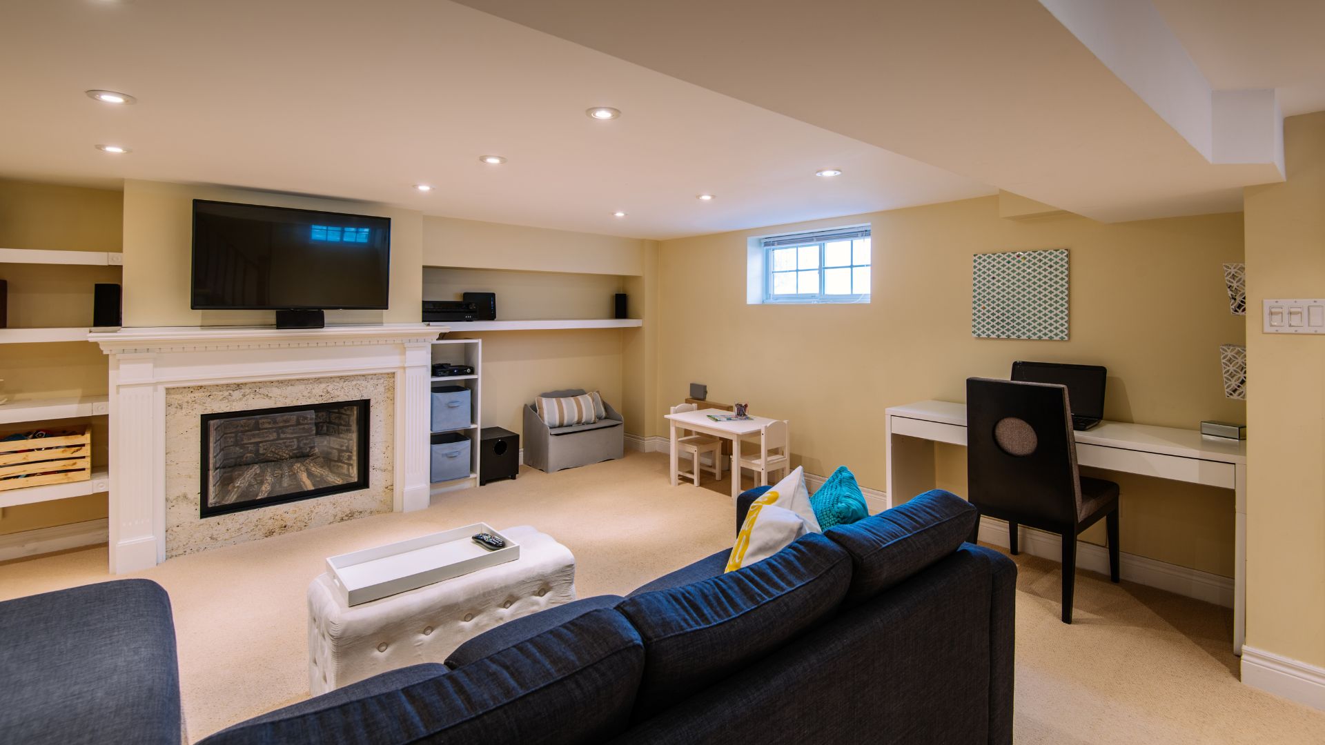Living room in basement with fireplace, television, with yellow walls and flooring
