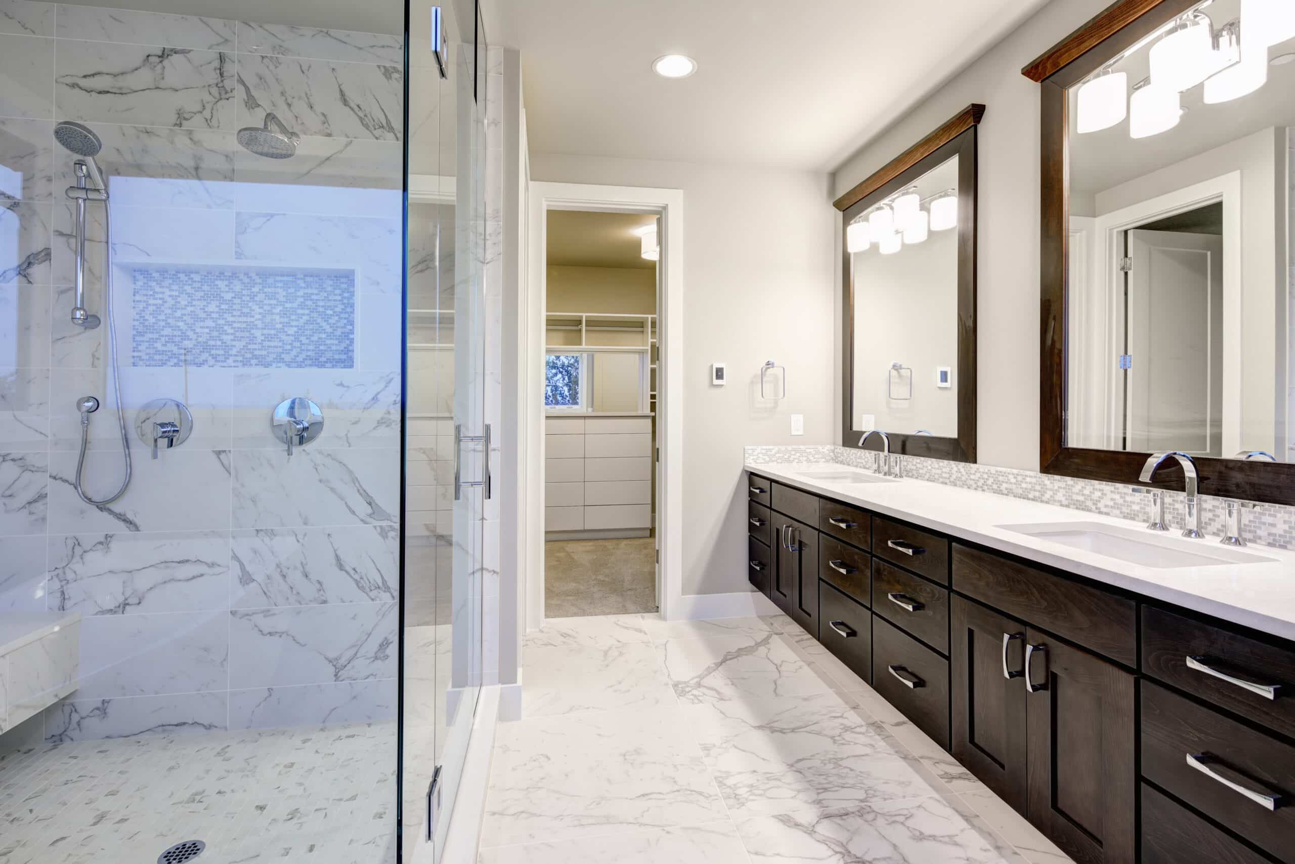 Bright and airy master bathroom features White Modern Double Vanity With Rich Brown Cabinets and marble walk-in shower.
