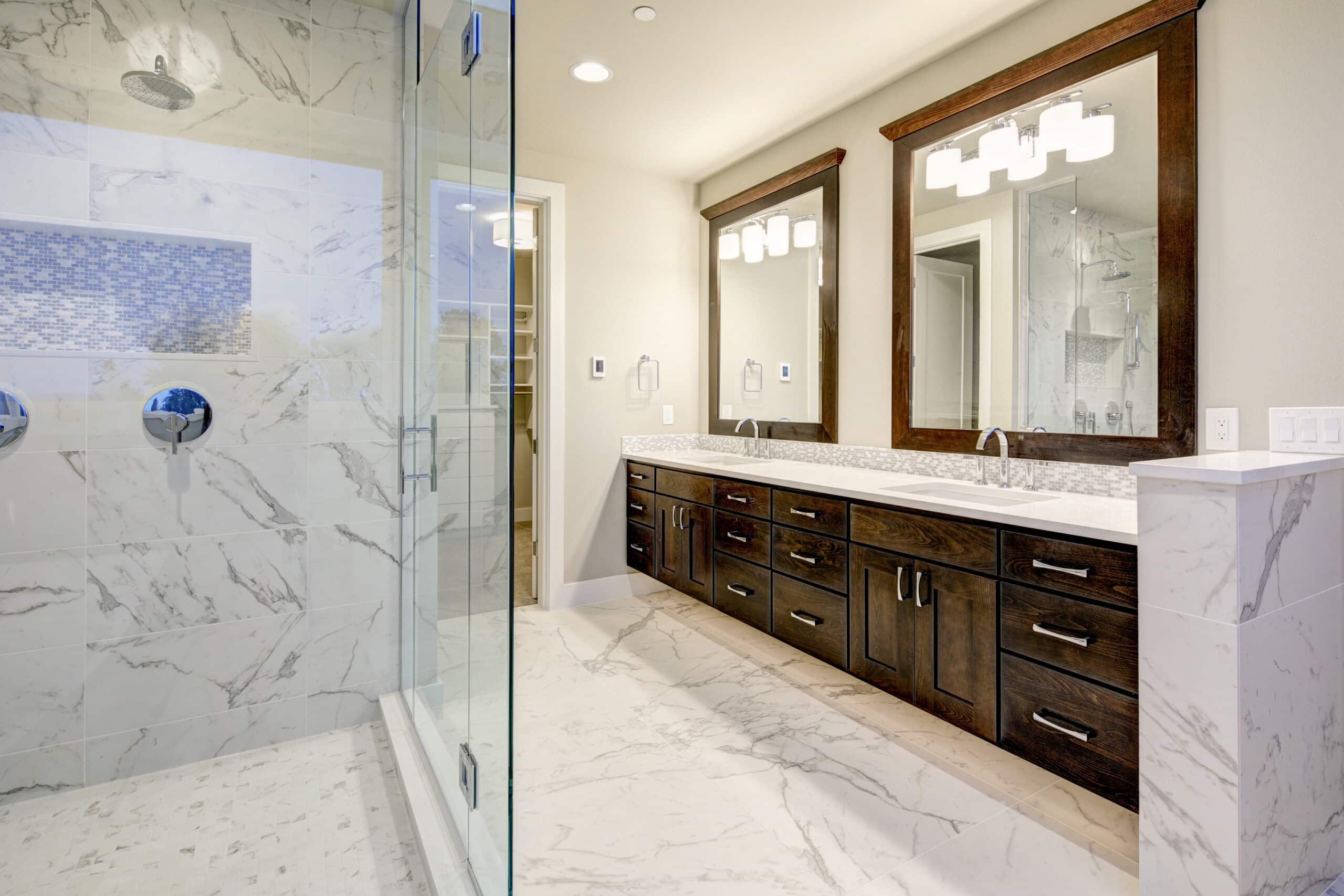 Bright and airy master bathroom features White Modern Double Vanity With Rich Brown Cabinets and marble walk-in shower.