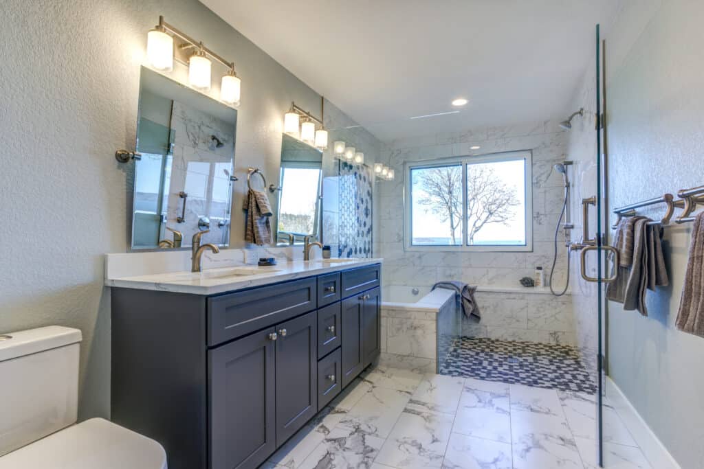 Clean white bathroom with dark brown shaker double-sink vanity with white marble countertop, a shower and a toilet