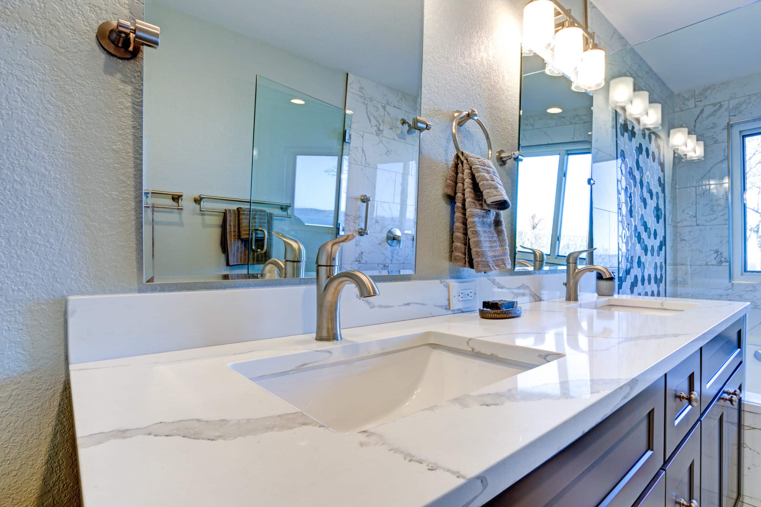 Luxury bathroom interior with blue dual washstand and marble counter top.