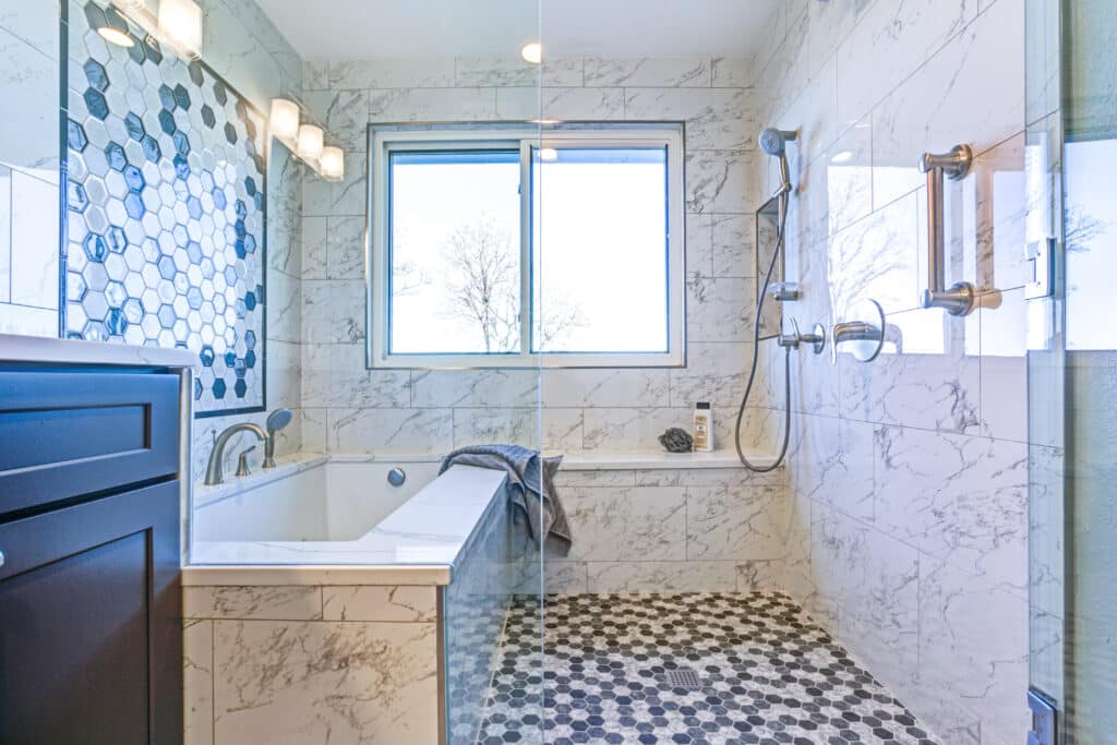 Luxury bathroom with Marble tile Surround and mosaic accent wall.