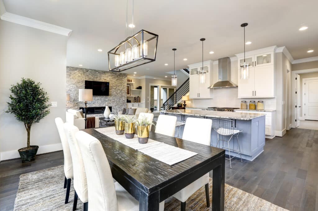 Luxury kitchen and living room with granite countertop and white shaker kitchen cabinets