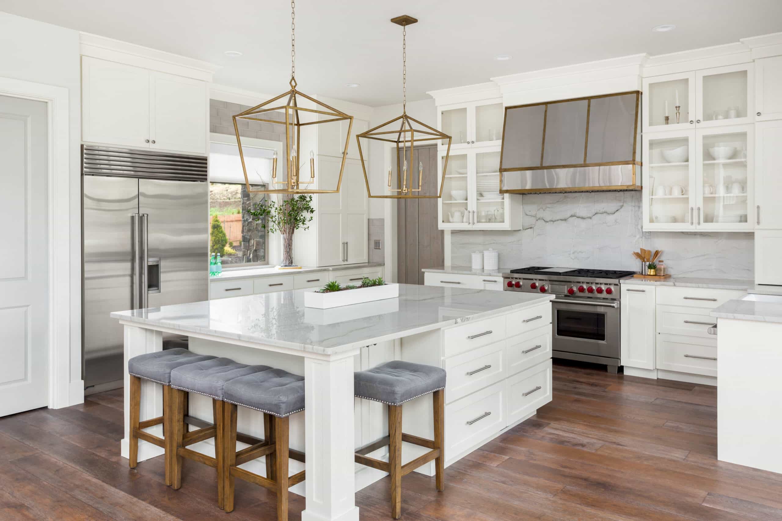White luxury kitchen countertop and cabinet design with wood flooring