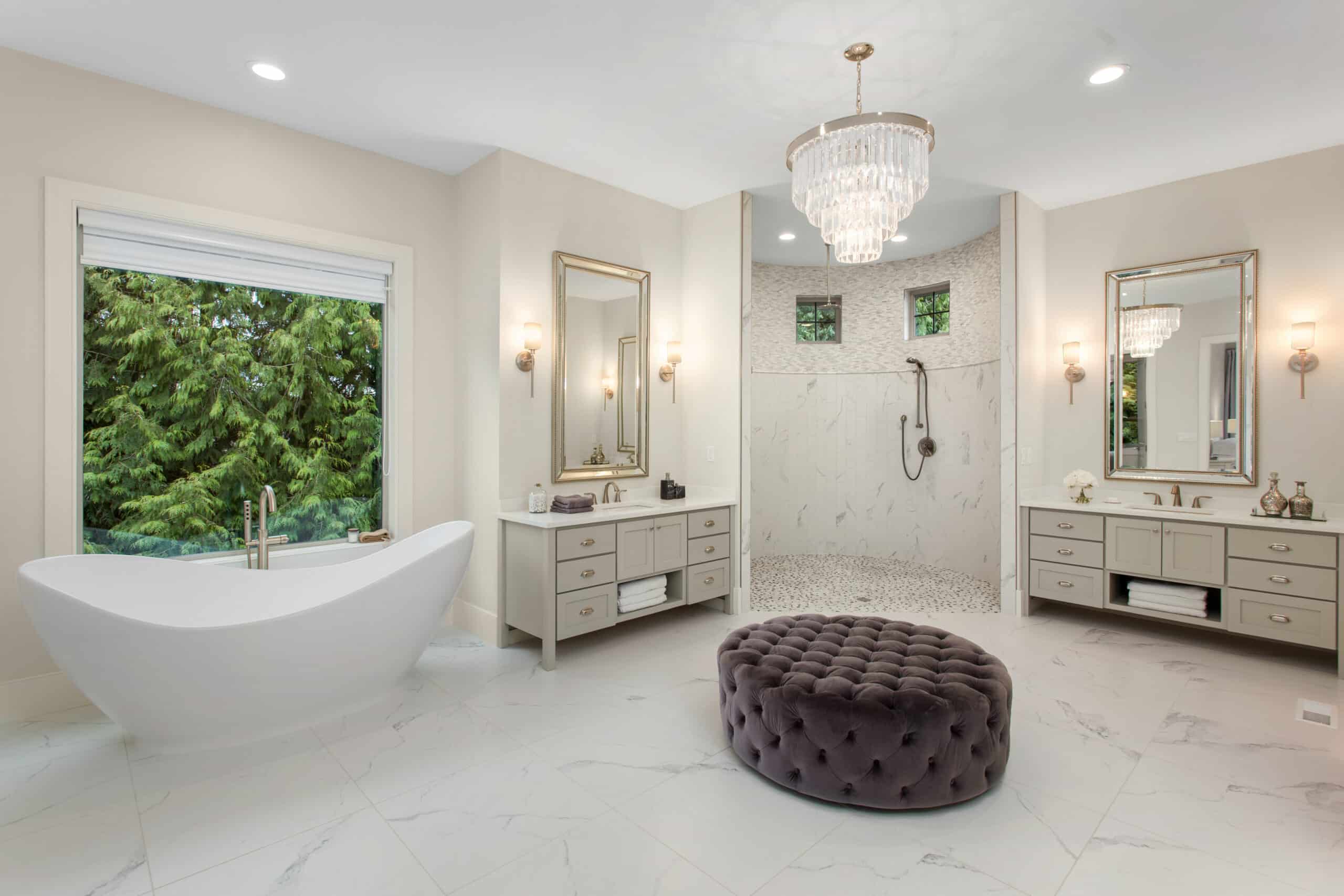Elegant master bathroom in new luxury home, with two vanities, and a bath tub and shower