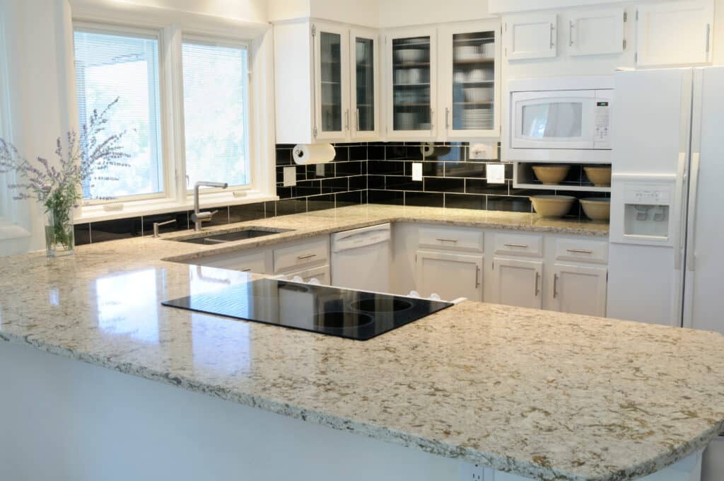 Elegant U-Shaped Kitchen style with white cabinets and beige countertop