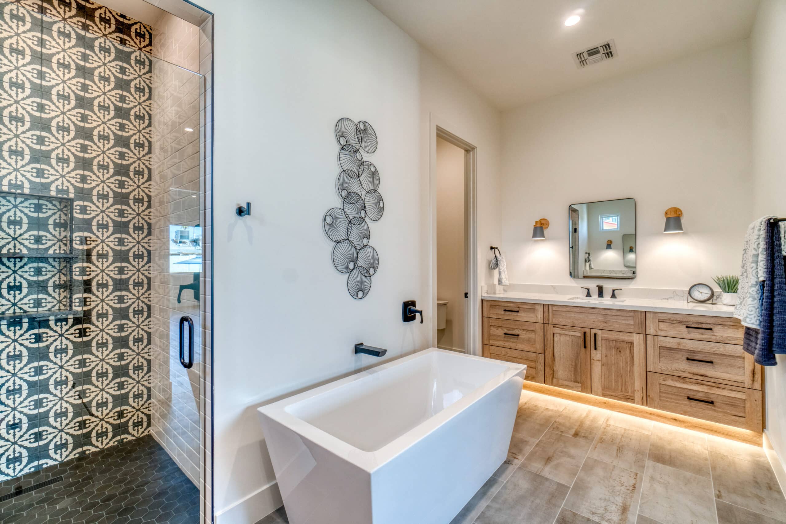 Traditional bathroom style with bath tub, brown single sink vanity, and a shower