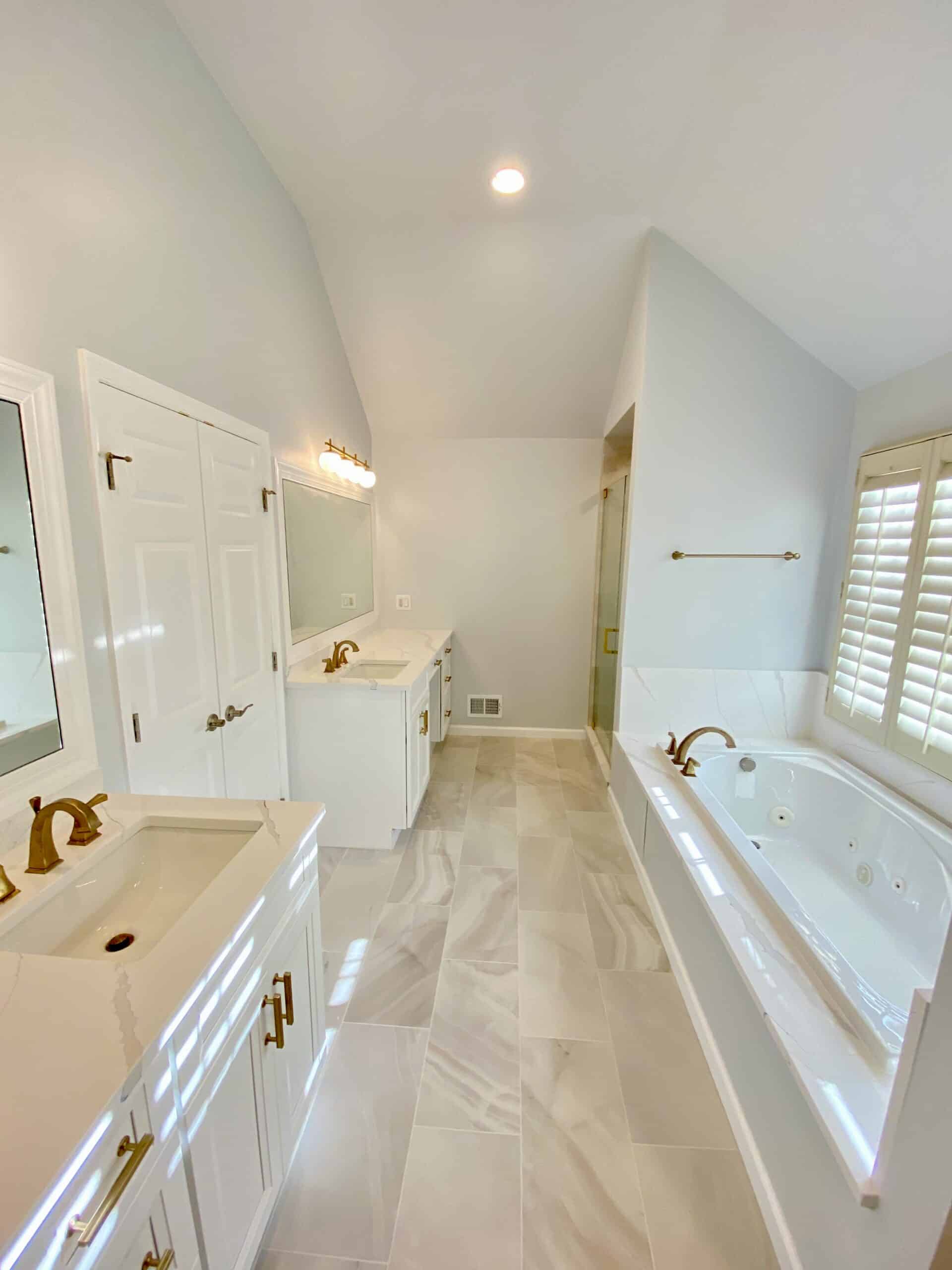 simple bathroom design with bath tub, shower and 2 single sink vanities