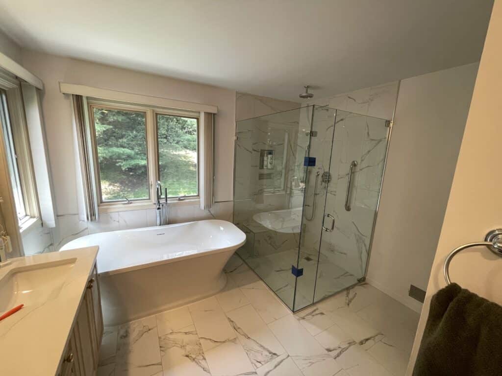modern bathroom design with shower enclosed with shower glass, and bath tub beside