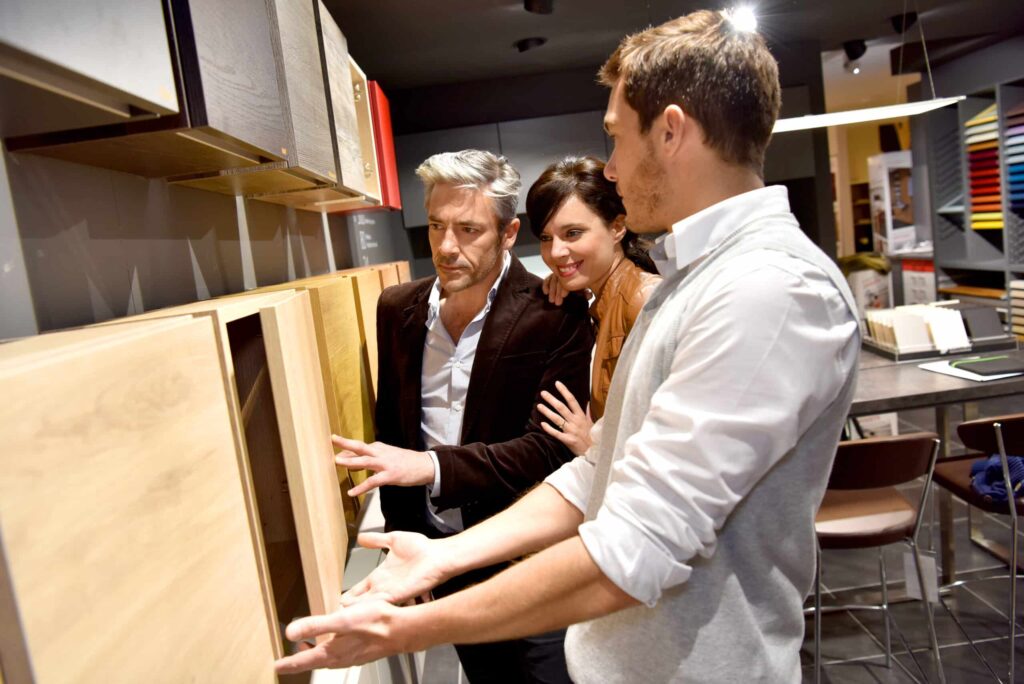 Couple with salesman in kitchen furniture store