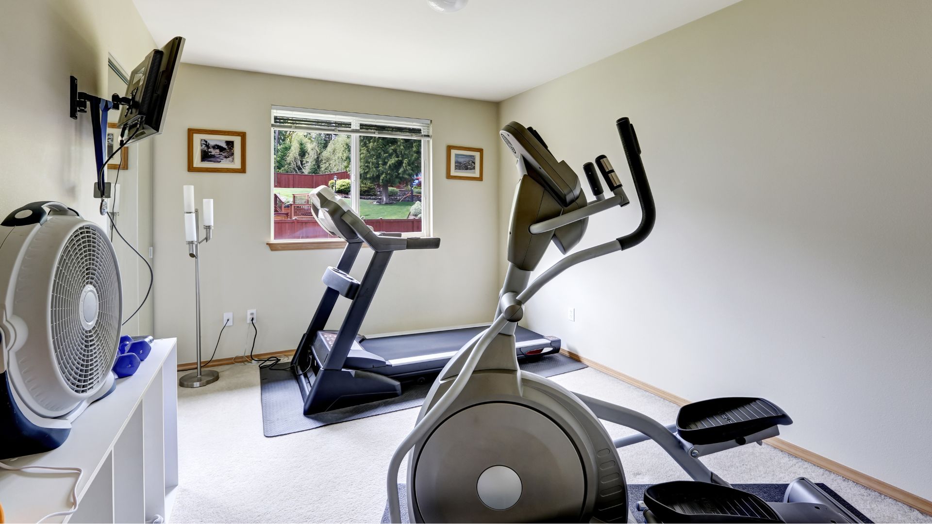 Small basement gym room with treadmill and elliptical bike
