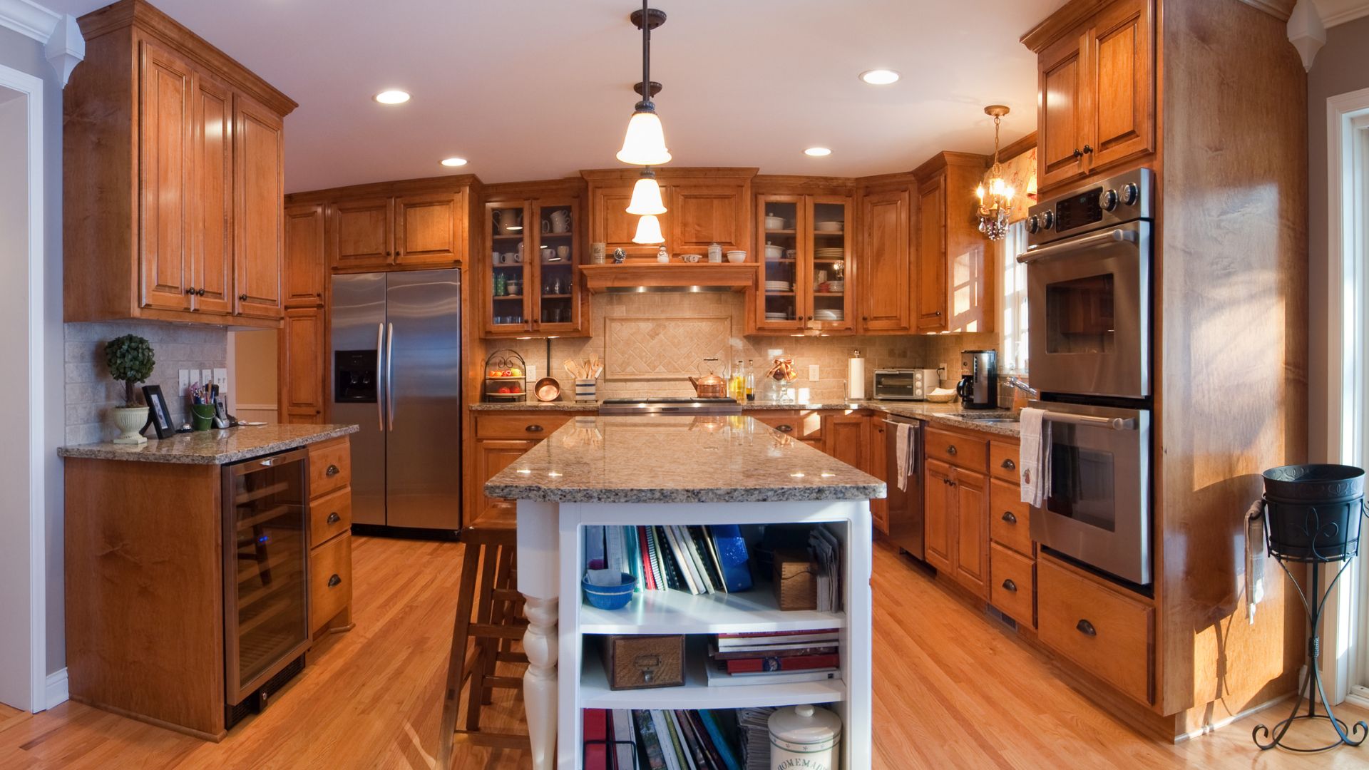 Traditional kitchen style in classic brown cabinets and granite countertop