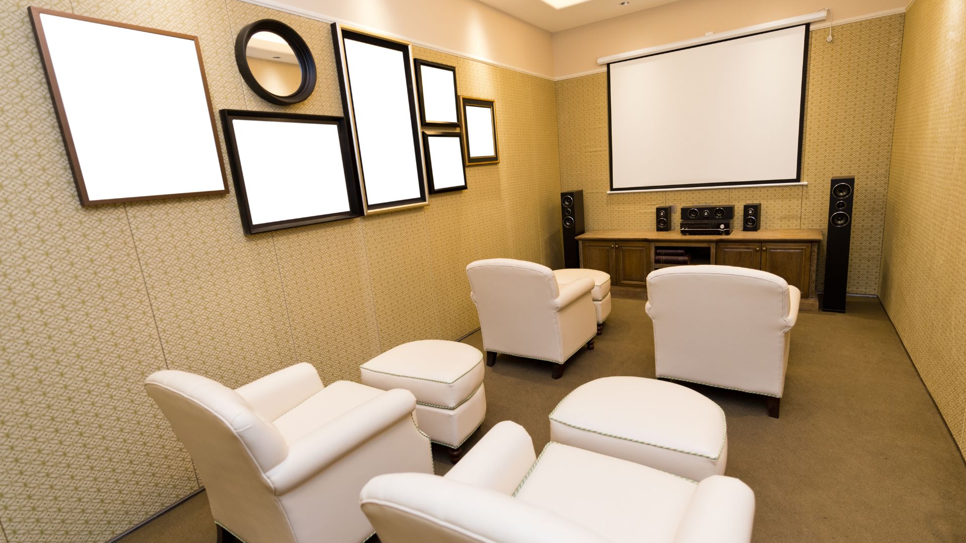 Small theatre room in basement with semi square style wall-mounted TV and white VIP chairs