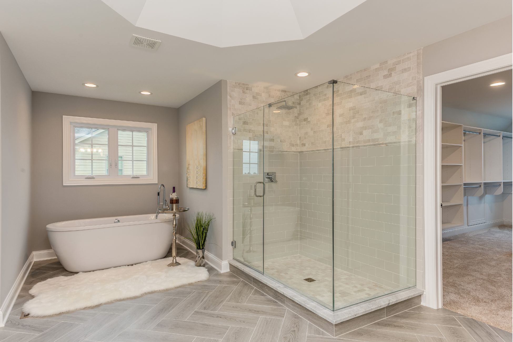 Spacious white bathroom with waterfall shower and bath tub