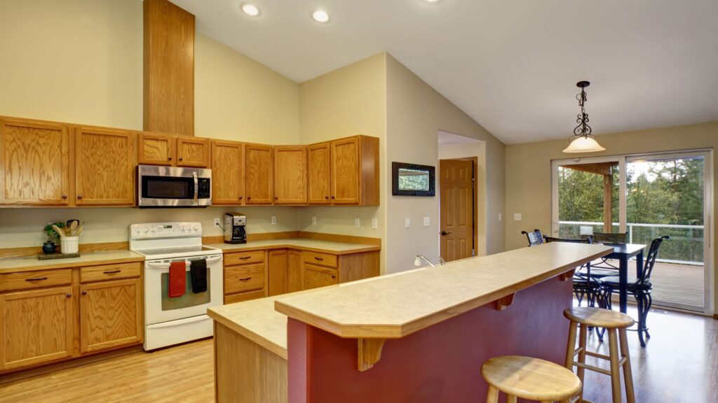 Traditional kitchen style in brown cabinets and cream countertop