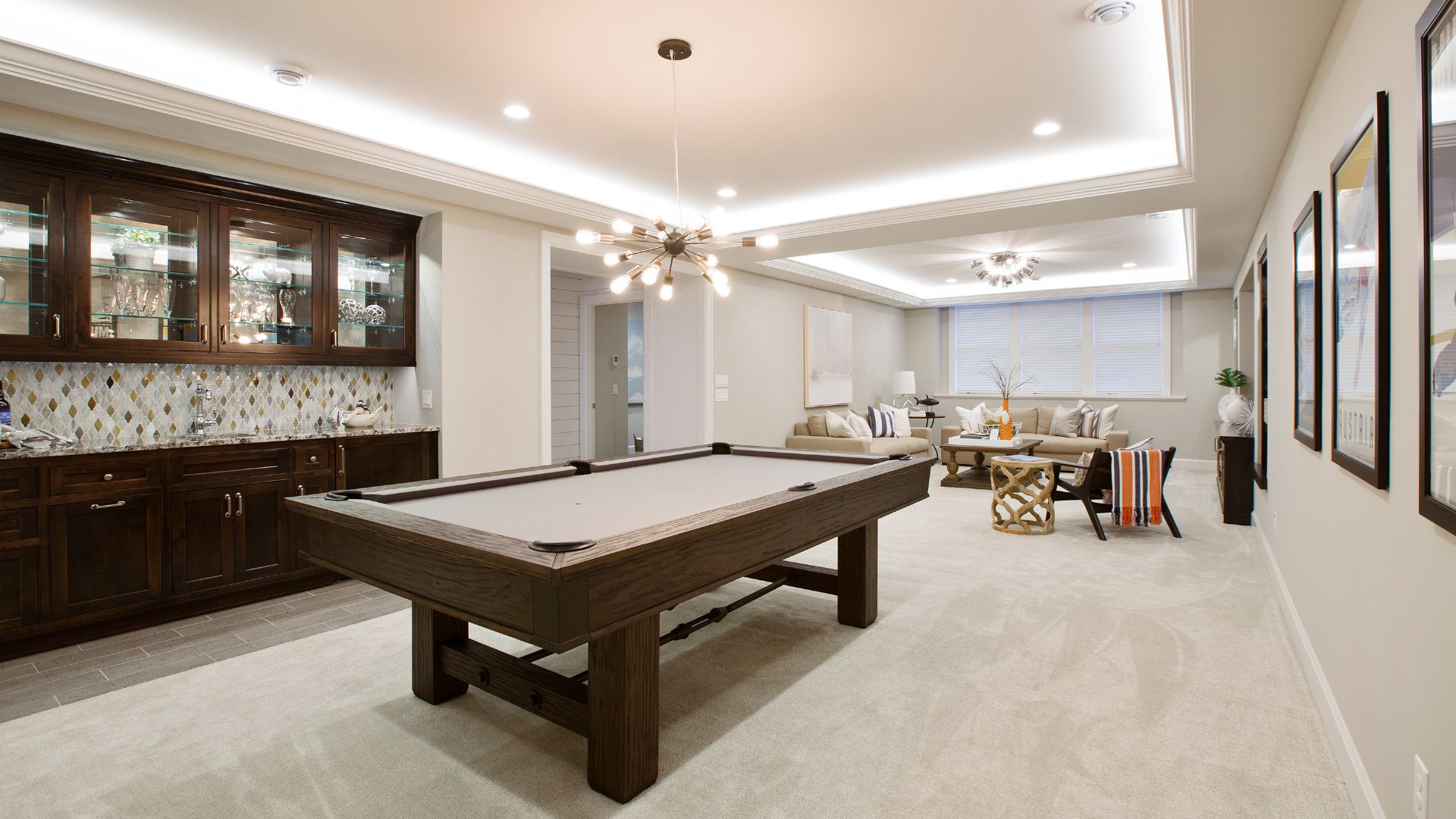 Modern basement entertainment area with billiard pool, kitchen cabinet and Sala set