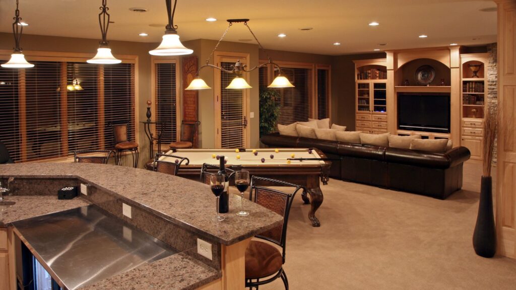 Entertainment room in basement with grey countertop