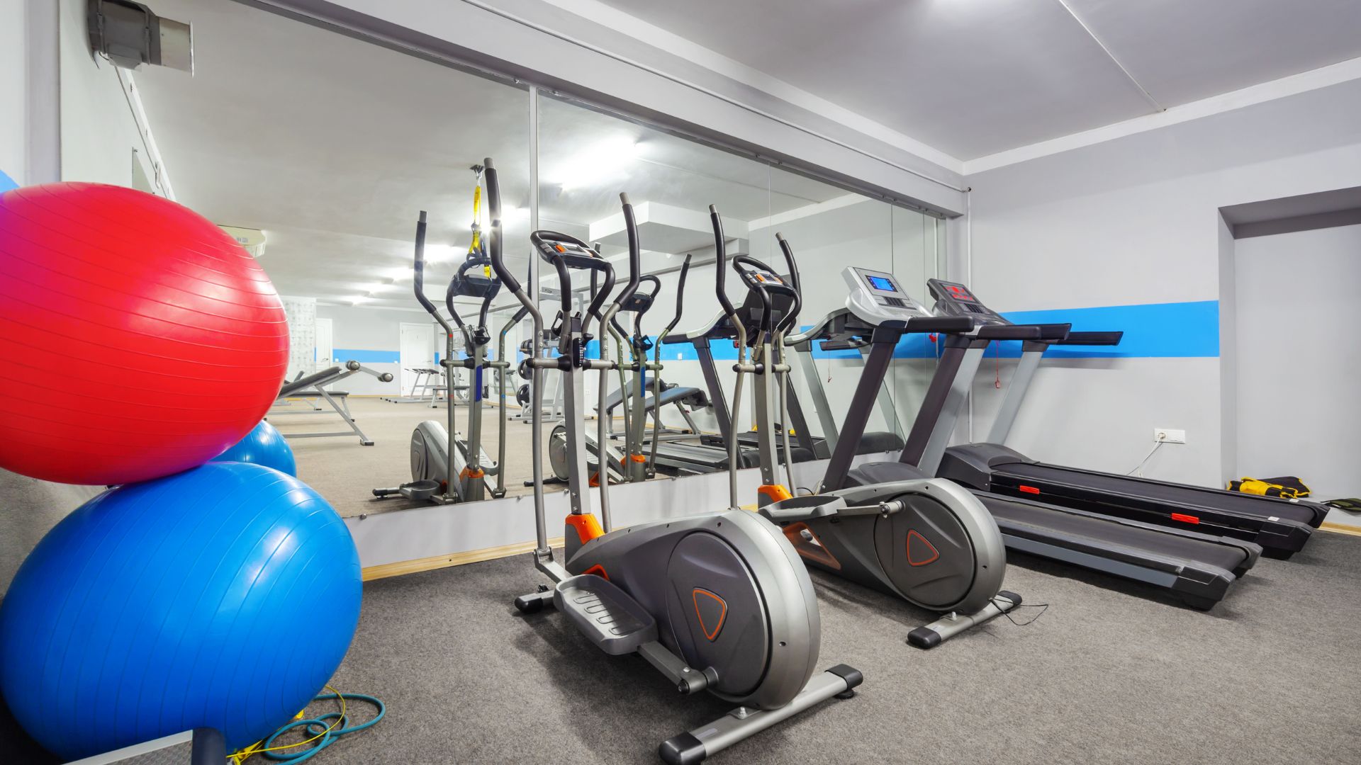 Basement Gym room with gym balls and stationary exercise bike