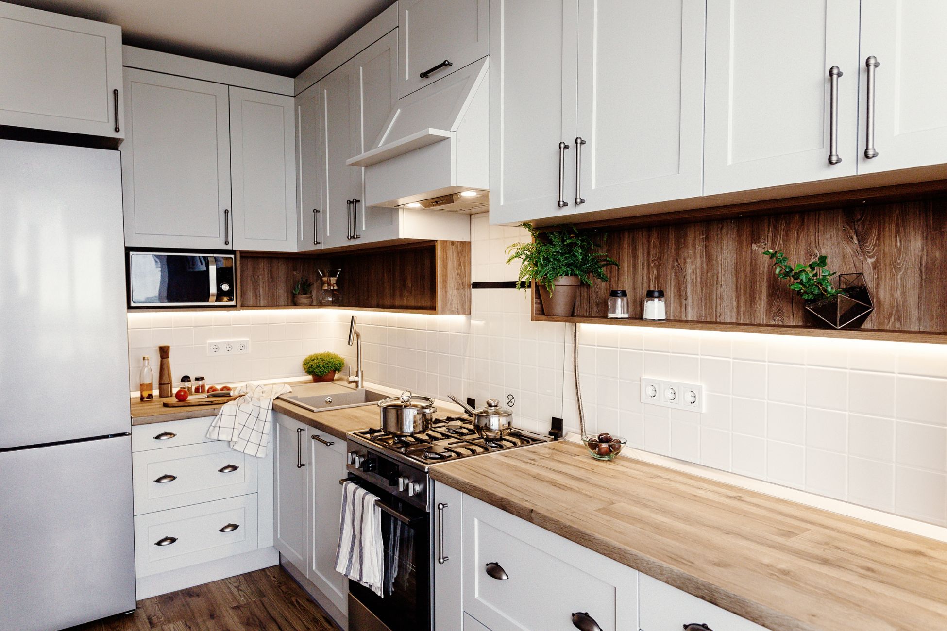 Simple white kitchen with wood countertop