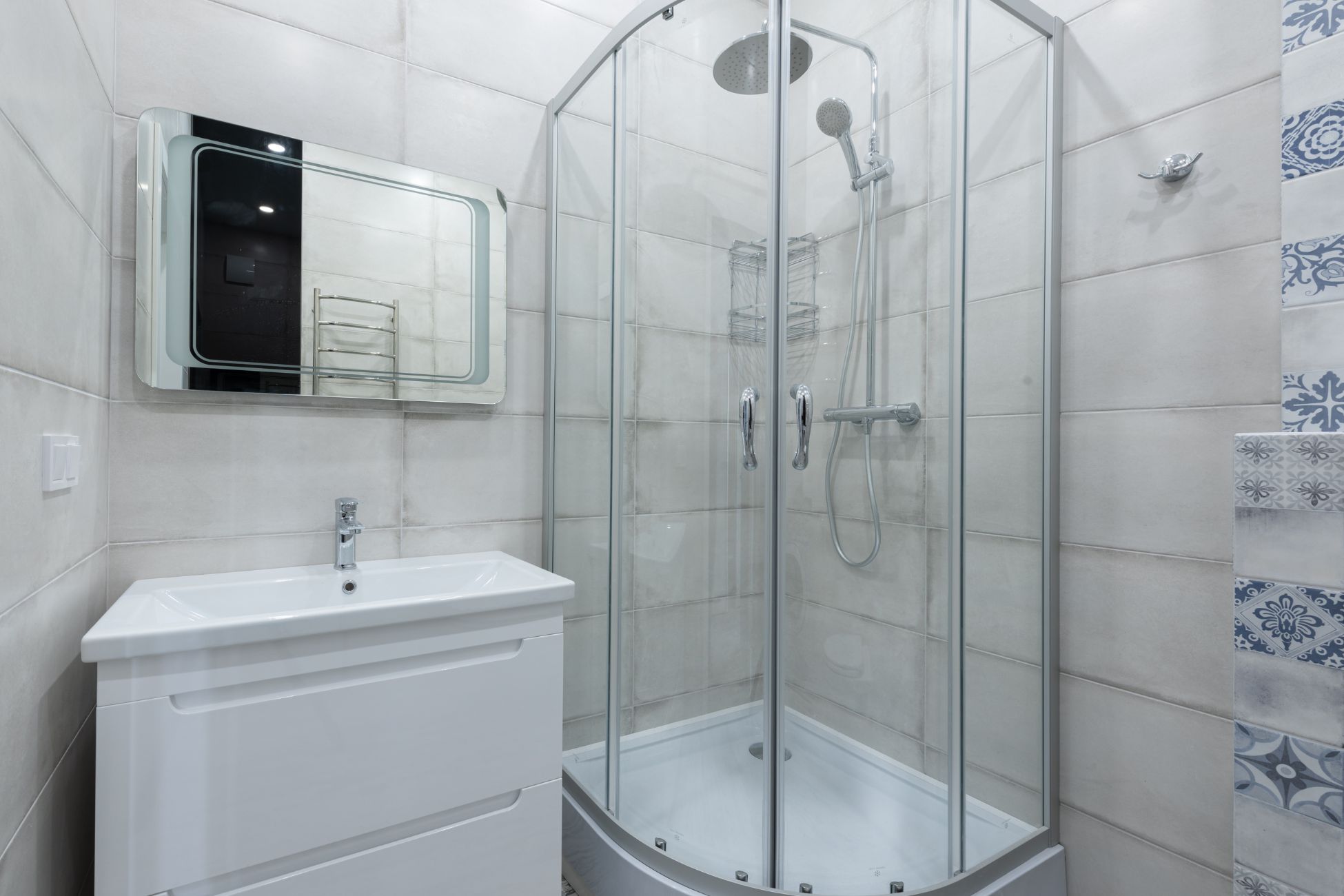 Small white Bathroom with curved enclosure shower