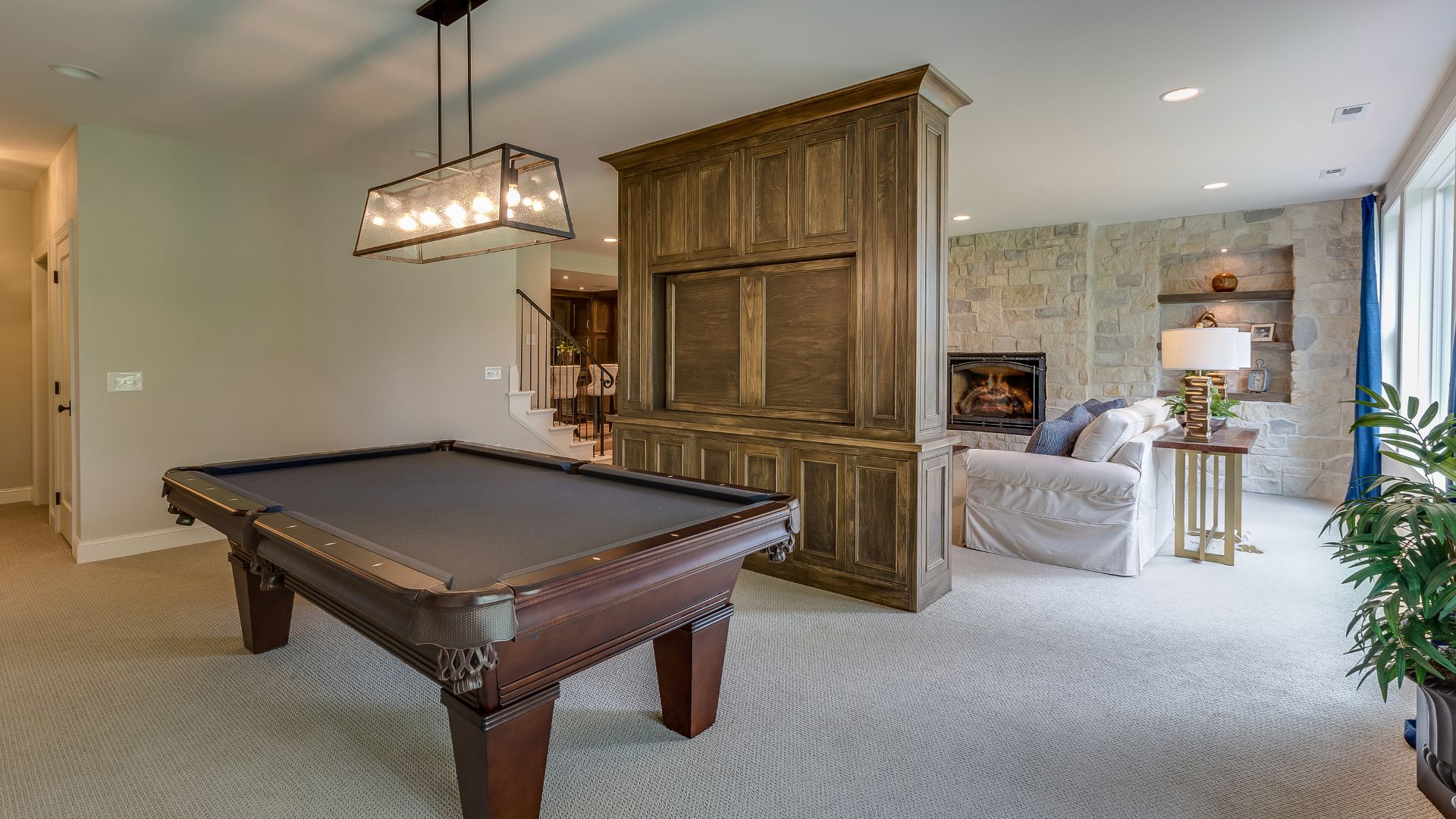 Basement Entertainment Area with billiard pool, and tall brown cabinet