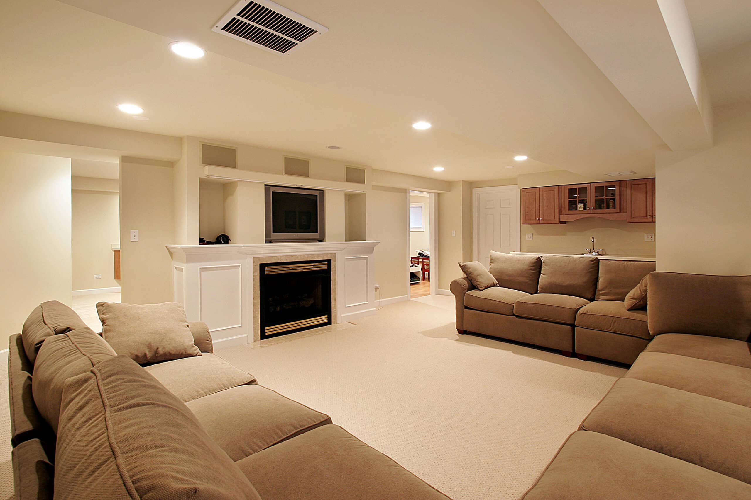 Basement in luxury home with white fireplace