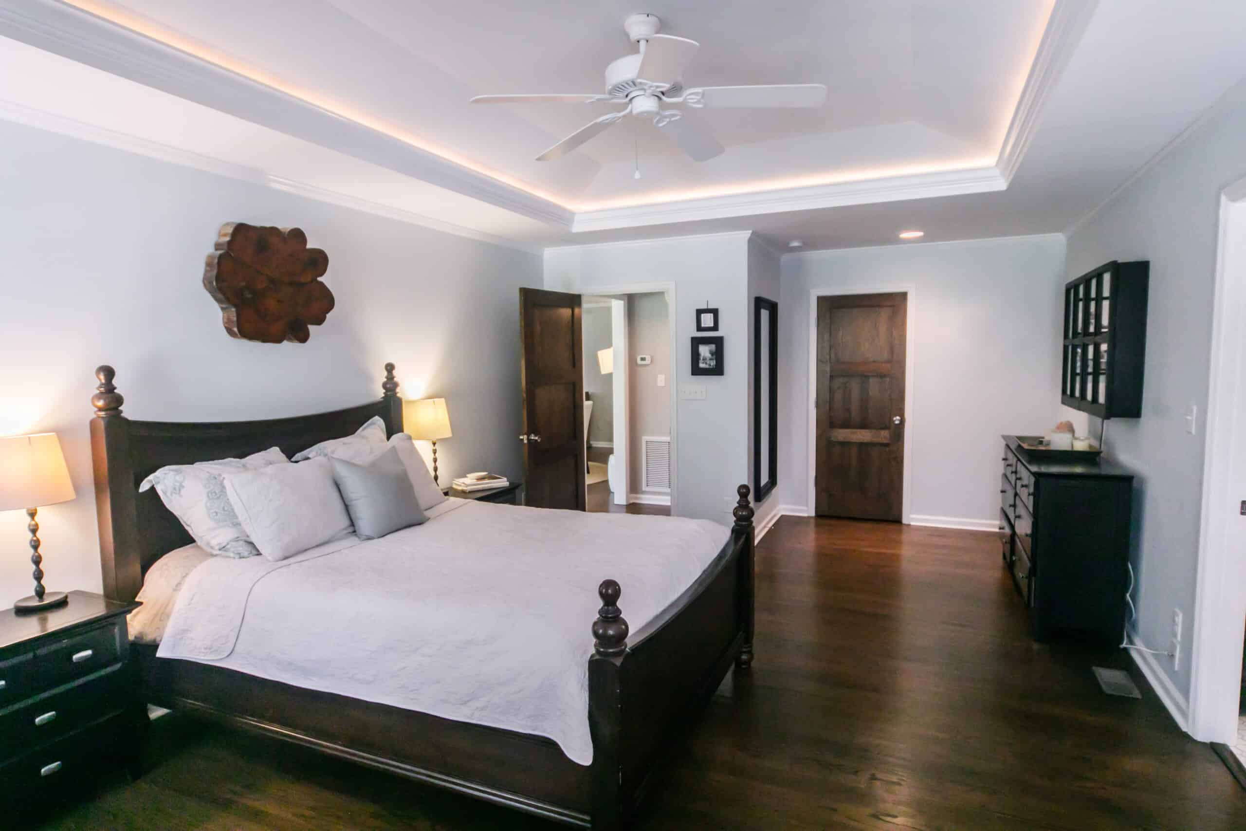 Master bedroom with king size bed and tray ceilings with up light