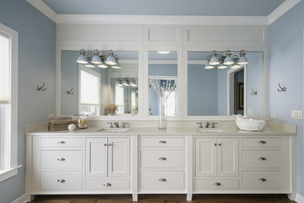 Beach bathroom style with white cabinet and sky blue painting