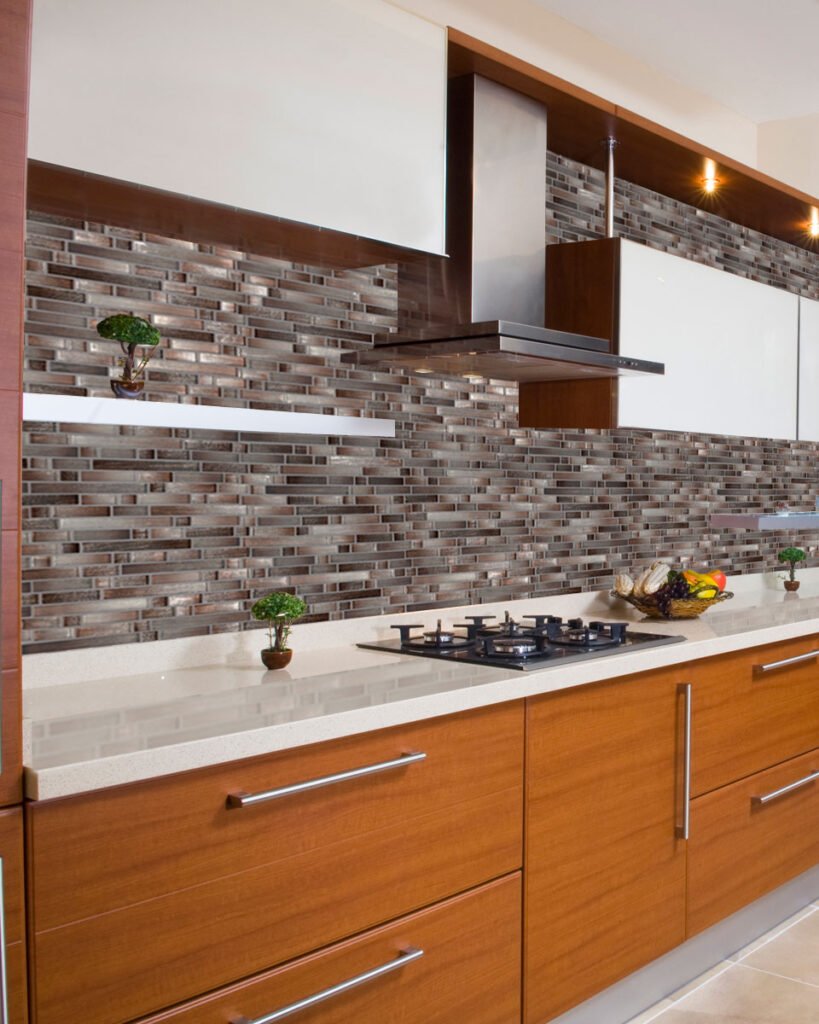 Elegant kitchen with brown kitchen cabinets, white countertop and glass tile backsplash
