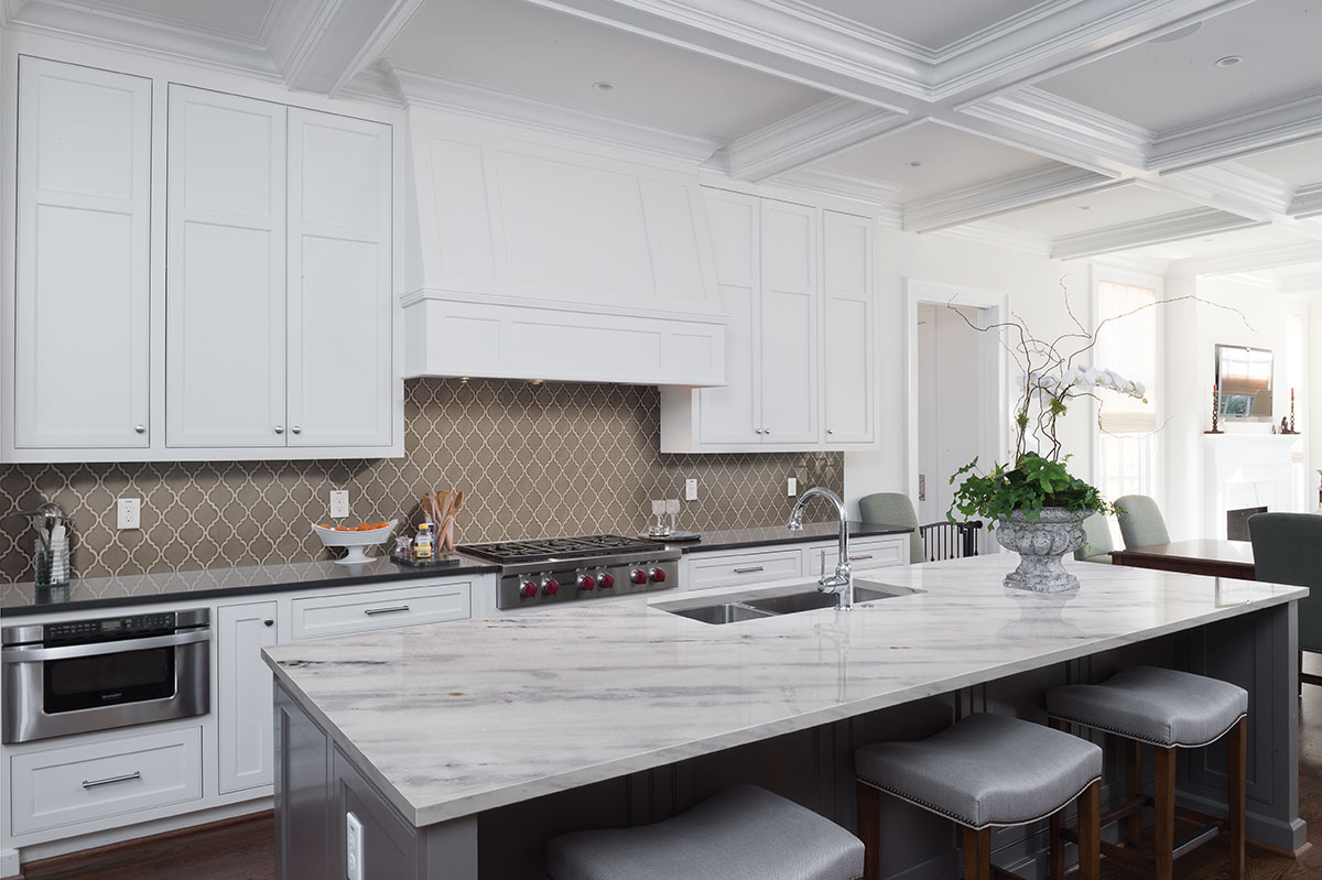 Clean white kitchen with arabescus white marble countertop